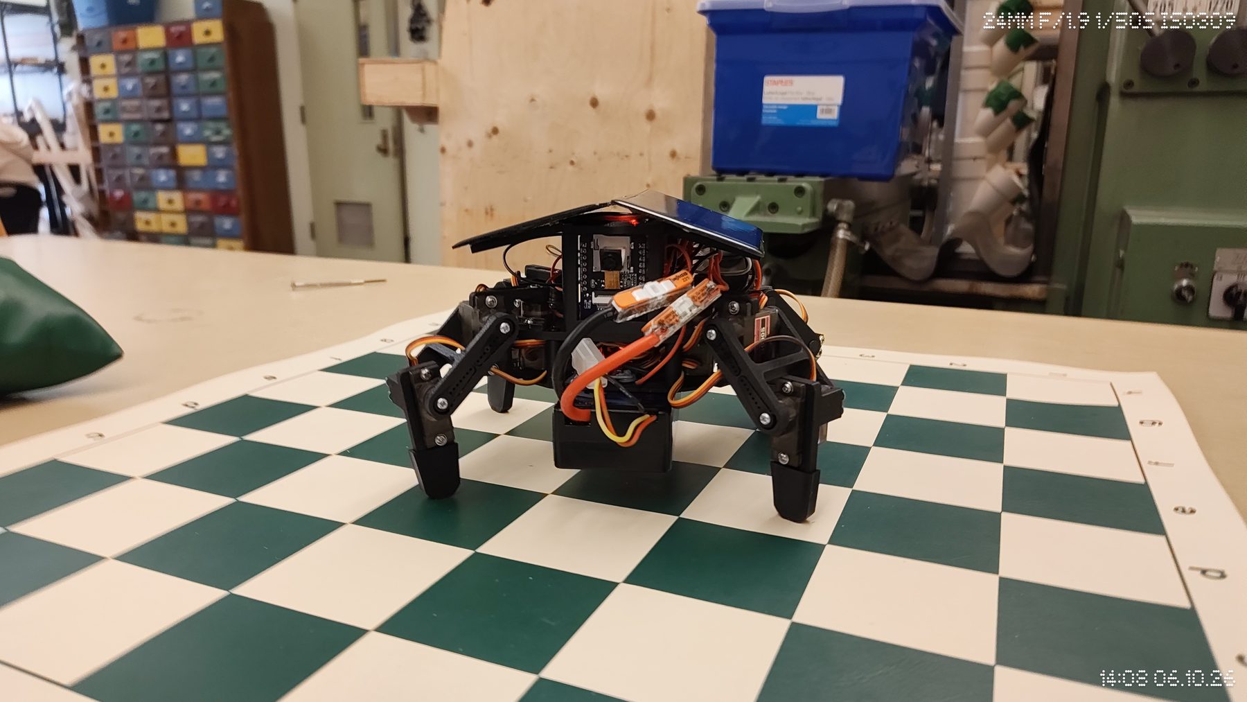 The assembled S.O.L.A.R. quadruped standing on a checkered workbench.